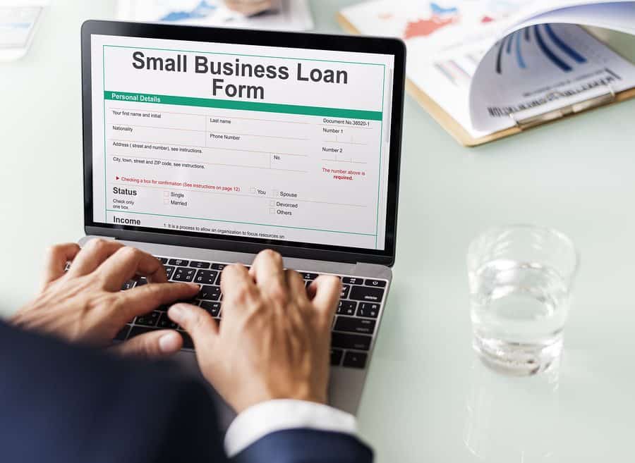Professional filling out business loan form online