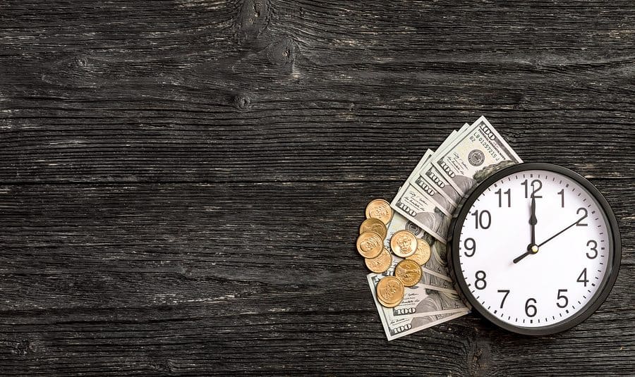 Get your merchant funds fast. Image description: Clock with money underneath it