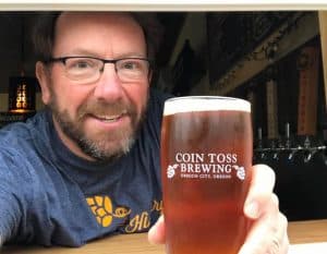 Photo showing Coin Toss Owner Tim Hohl serving out of the taproom's new window