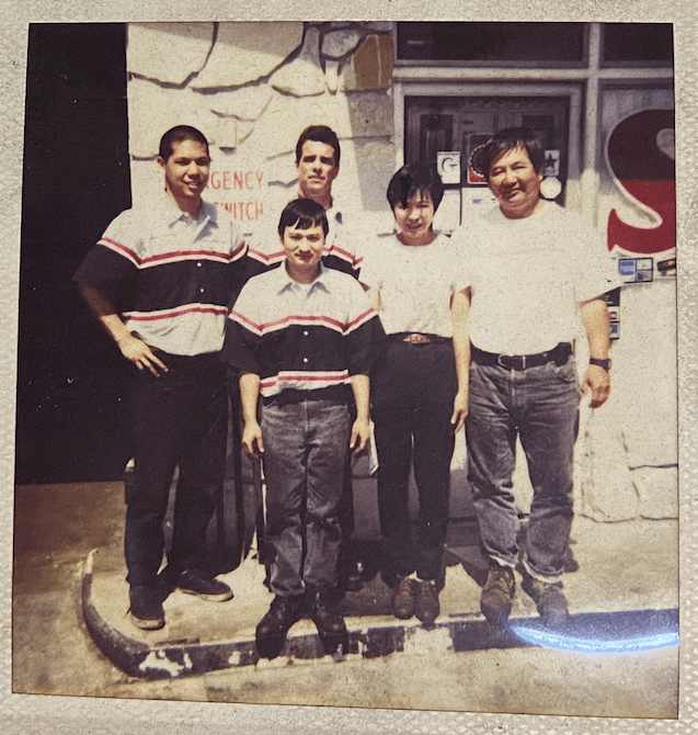 mechanics standing in front of auto repair shop