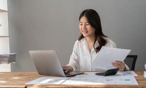 woman at computer looking at finances