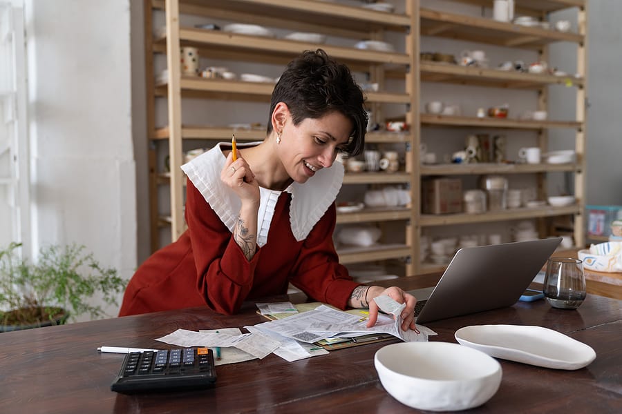 Woman in peter pan collar transfers money from one bank to another. 