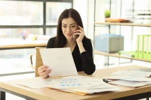 woman sitting at desk looking at a business line of credit